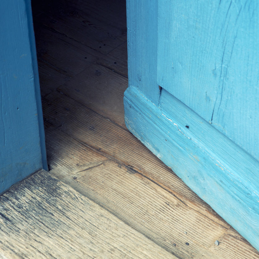 closeup of open old blue wooden door closeup of an open old blue wooden door